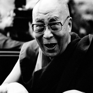 His Holiness Dalai Lama XIV smiling with his mouth open.