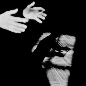 Hands of Eivind Gullberg Jensen with his shadow on the wooden floor.