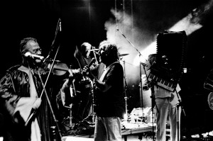 Emir Kusturica with violin player on the stage at the concert of No Smoking Orchestra.