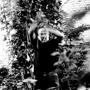 Jean-Marc Barr fighting plants in a jungle house.