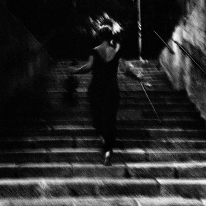 Mari Samuelsen walks the stairs holding violin and fiddlestick.