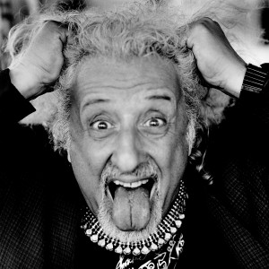 Misha Maisky sticks his tongue out holding his hair like Einstein.
